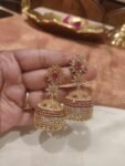 Poised Golden  Jhumka With Crystal and Red Floral design