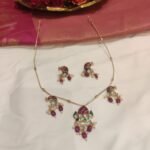 Lustrous Golden Chain With Floral Peacock Pendant Red White Beads