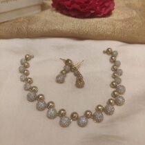 Enigmatic Crystal golden finish round Necklace