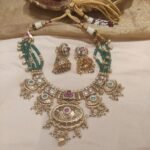 Lustrous golden bridal with green moti necklace