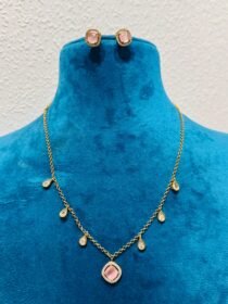 Delicate pink rose with droplet with golden chain