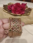 Floral ruby green stone golden set